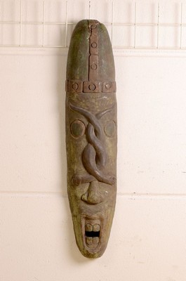 Image Face mask, probably Mahafaly/Madagascar, 20th century, wood, carved, fragmentary painted green, mannered elongated skull with a pair ofcoiled snakes over the nose, open mouth with two pairs of teeth, traces of age, l. 103 cm